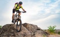 Cyclist Riding the Bike on Autumn Rocky Trail at Sunset. Extreme Sport and Enduro Biking Concept. Royalty Free Stock Photo