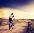 Cyclist Riding a Bike on Country Road. Toned Photo Royalty Free Stock Photo