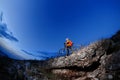 Cyclist Riding the Bike Down Hill on the Mountain Rocky at Sunset. Royalty Free Stock Photo