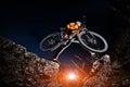 Cyclist Riding the Bike Down Hill on the Mountain Rocky at Sunset. Royalty Free Stock Photo