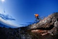 Cyclist Riding the Bike Down Hill on the Mountain Rocky at Sunset. Royalty Free Stock Photo