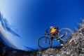 Cyclist Riding the Bike Down Hill on the Mountain Rocky Trail at Sunset. Extreme Sports Royalty Free Stock Photo