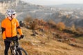 Cyclist Riding the Bike Down Rocky Hill. Extreme Sport Concept. Space for Text. Royalty Free Stock Photo