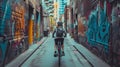 Cyclist riding bike down an urban alley adorned with vibrant graffiti.