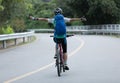 cyclist riding bike with outstretched arms on road Royalty Free Stock Photo