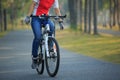 Cyclist riding bike with outstretched arms in tropical park Royalty Free Stock Photo