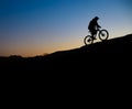 Cyclist Riding the Bike on Rocky Trail at Sunset. Extreme Sport and Enduro Biking Concept. Royalty Free Stock Photo