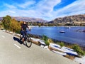 Cyclist Riding Bike On The Shore Of Lake Wanaka In Otago Region Of The South Island Of New Zealand