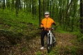 Cyclist Riding the Bike on a Trail in Summer Forest Royalty Free Stock Photo