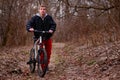 Cyclist riding a mountain bike along the forest road Royalty Free Stock Photo