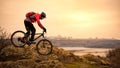 Cyclist Riding the Mountain Bike on the Rocky Trail at Autumn Evening. Extreme Sport and Enduro Cycling Concept. Royalty Free Stock Photo