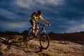 Cyclist Riding the Mountain Bike on Rocky Trail in the Evening. Extreme Sport and Enduro Biking Concept. Royalty Free Stock Photo