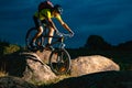 Cyclist Riding the Mountain Bike on Rocky Trail in the Evening. Extreme Sport and Enduro Biking Concept. Royalty Free Stock Photo
