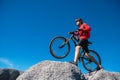 Cyclist riding mountain bike on the rocky trail at sunset, Extreme mountain bike sport athlete man riding outdoors lifestyle trail Royalty Free Stock Photo