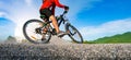 Cyclist riding mountain bike on the rocky trail at sunset, Extreme mountain bike sport athlete man riding outdoors lifestyle trail Royalty Free Stock Photo