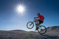 Cyclist riding mountain bike on the rocky trail at sunset, Extreme mountain bike sport athlete man riding outdoors lifestyle Royalty Free Stock Photo