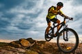 Cyclist Riding the Mountain Bike on Rocky Trail at Sunset. Extreme Sport and Enduro Biking Concept.