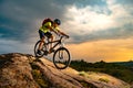 Cyclist Riding the Mountain Bike on Rocky Trail at Sunset. Extreme Sport and Enduro Biking Concept. Royalty Free Stock Photo