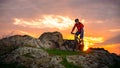 Cyclist Riding Mountain Bike on the Spring Rocky Trail at Beautiful Sunset. Extreme Sports and Adventure Concept. Royalty Free Stock Photo