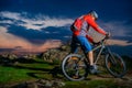 Cyclist Riding Mountain Bike on Spring Rocky Trail at Beautiful Sunset. Extreme Sports and Adventure Concept. Royalty Free Stock Photo