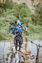 Cyclist riding on the old bridge in the mountains Royalty Free Stock Photo