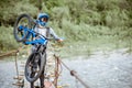 Cyclist riding on the old bridge in the mountains Royalty Free Stock Photo