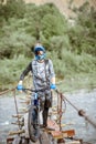 Cyclist riding on the old bridge in the mountains Royalty Free Stock Photo