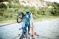 Cyclist riding on the old bridge in the mountains Royalty Free Stock Photo