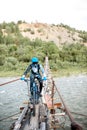 Cyclist riding on the old bridge in the mountains Royalty Free Stock Photo