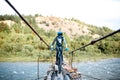 Cyclist riding on the old bridge in the mountains Royalty Free Stock Photo