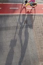 Cyclist riding on red urban bike lane in Las Palmas de Gran Canaria,bike shadow. .Urban bike lane concept Royalty Free Stock Photo