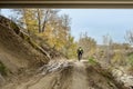 A cyclist on a route along a sandy and muddy track Royalty Free Stock Photo