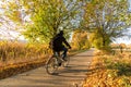 Cyclist on rural bike lane in autumn landscape Royalty Free Stock Photo