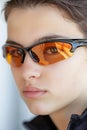 Cyclist s focused eyes through sunglasses, symbolizing concentration in summer olympic sports