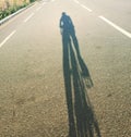 Cyclist shadow on tarmac road