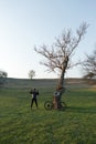 Cyclist in shorts and jersey on a modern carbon hardtail bike with an air suspension fork standing on a cliff against the backgrou