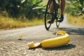 cyclist swerving to avoid banana peel on road Royalty Free Stock Photo