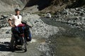 Cyclist taking a break on Karakorum Highway Royalty Free Stock Photo