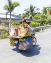 Cyclist transports fruits on motorcycle in My Tho, Vietnam