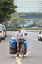 Cyclist transports waste cans on an old bike, Guangzhou, China