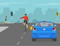 Cyclist turning left on crossroad. Back view of a cyclist showing turning gesture while cycling. Left turning traffic flow.