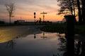 Cyclist is waiting near a signpost in the early morning