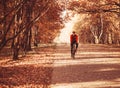 Cyclist wearing a helmet and glasses riding a bike in the autumn Park, autumn landscape