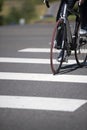 Cyclist crosses the city road with pedestrian crossing on road b