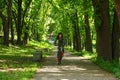 Cyclist woman riding a bicycle in park Royalty Free Stock Photo