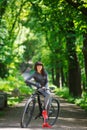 Cyclist woman riding a bicycle in park Royalty Free Stock Photo