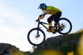 Cyclist in Yellow T-shirt and Helmet Riding Mountain Bike Down Rocky Hill. Extreme Sport Concept. Royalty Free Stock Photo