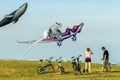 Cyclists admire large flying multi colored kites at East Coast Park Royalty Free Stock Photo