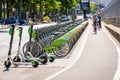 Cyclists biking past a Velib docking station in Paris, France