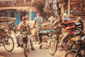 Cyclists on busy streets with rushing people, vehicles, bycycles in old indian city traffic jam